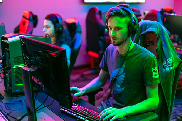 An esports team member playing a video game.