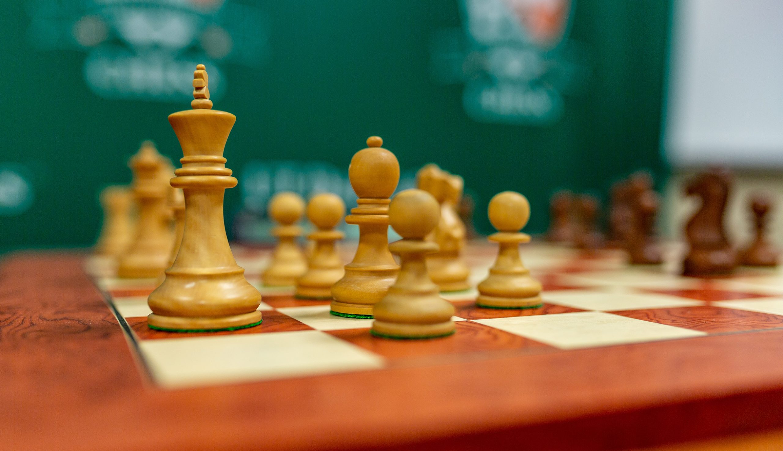 chess pieces on a wooden chess board